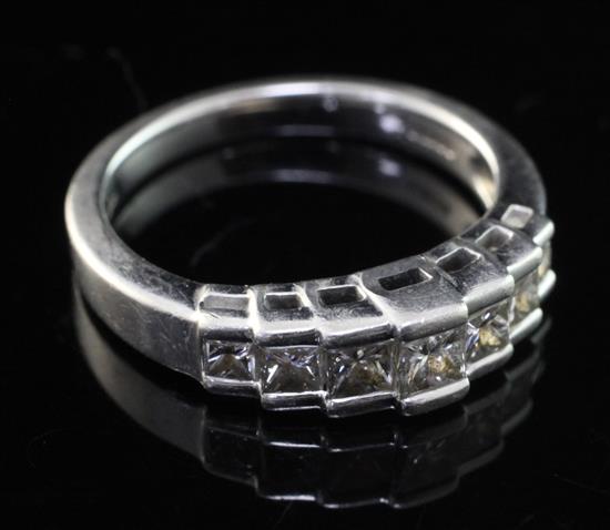 A modern platinum and graduated seven stone princess cut diamond half hoop ring, size L.